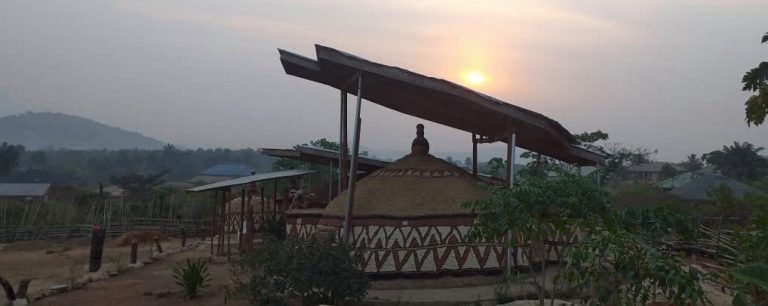 a picture of a sculpture at the akodi orisa during sun set