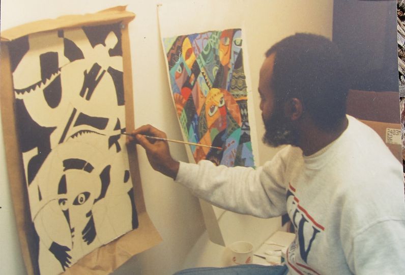 a picture of moyo okediji working on a art piece