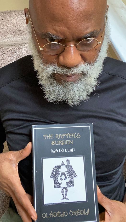 apicture of moyo okediji holding a book titled THE RAFTERS BURDEN (AJA LO LERU)