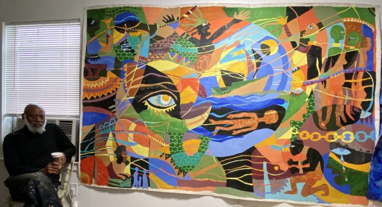 a picture showing moyo okedijis art piece hanged on a wall