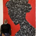 a picture showing moyo okediji sitting next to his artwork