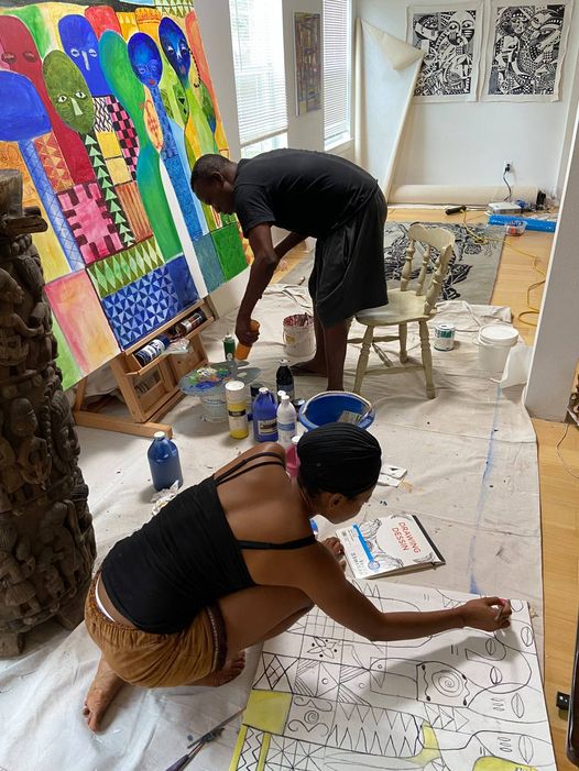 A picture of Moyo Okediji and his apprentice working on his artwork