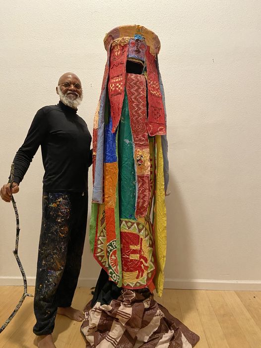 a picture showing moyo okediji poised for the camera with his egungun regalia